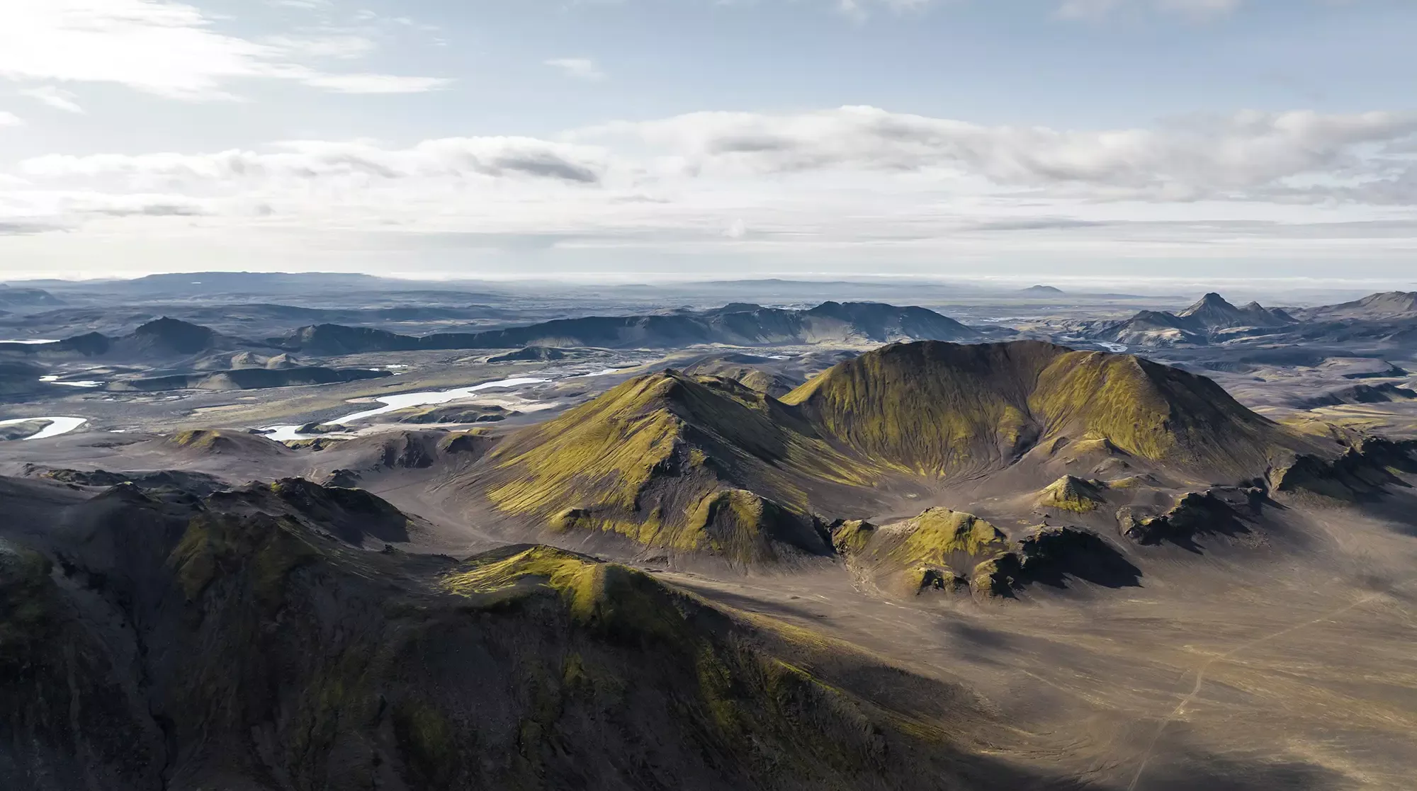 Aerial view of a beautiful mountain landscape with river at sunset in Iceland
